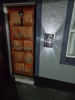 a door with a light on the side of a wall at Mantsho Lagoon