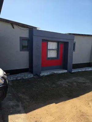 a house with a red door with a window at Mantsho Lagoon