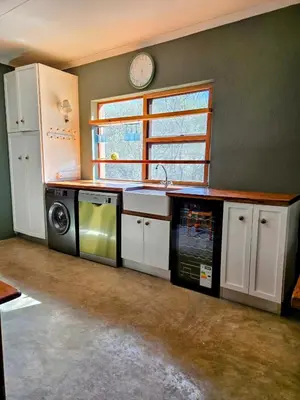 a kitchen with a sink and a microwave at Home with Thelana in Marloth Park