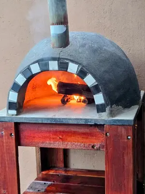 a pizza oven with a fire inside of it at Home with Thelana in Marloth Park