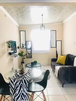 a living room with a couch and a table at Blanc and Bold in Vosburg