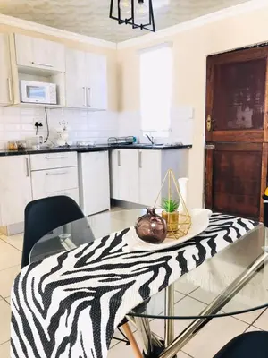 a kitchen with a table with a bowl on it at Blanc and Bold in Vosburg
