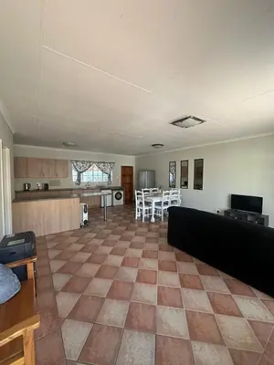 a living room with a couch and a kitchen at Klaverton Daisy in Benoni