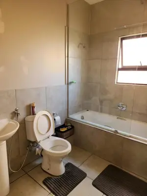 a bathroom with a toilet and a tub and a sink at Secret pillow in Trichardt