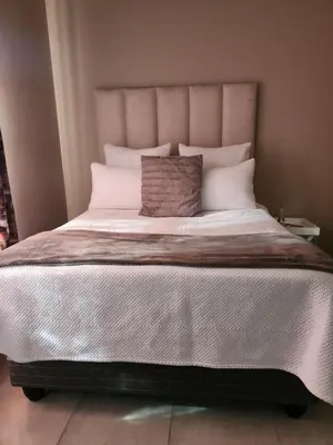 a large bed with white sheets and pillows at Secret pillow in Trichardt