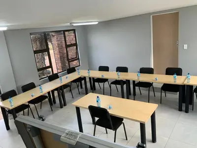 a row of tables and chairs in a room at Glowti Event & Guest House in Centurion