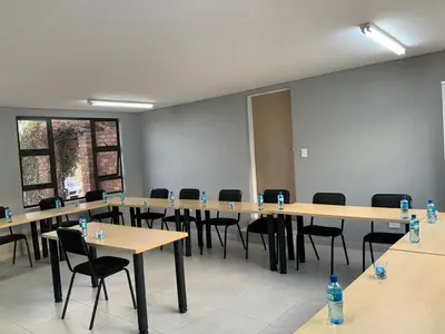 a large room with tables and chairs and water bottles at Glowti Event & Guest House in Centurion