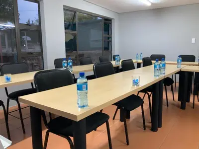 a row of tables with bottles of water on them at Glowti Event & Guest House in Centurion