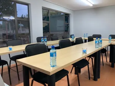 a row of tables with bottles of water on them at Glowti Event & Guest House in Centurion