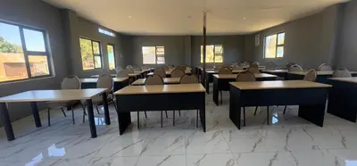 a dining room with tables and chairs and windows at Glowti Event & Guest House in Centurion