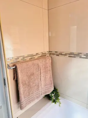 a bathroom with a towel rack and a shower at Dubai guest house in Soshanguve