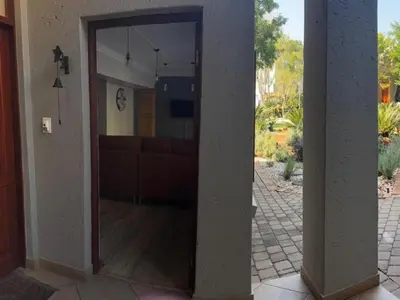 an open door into a living room with a couch at Big 5 Cottage in Pretoria