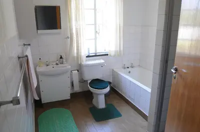 a bathroom with a toilet and a tub and a sink at Luisa's Place in Pretoria