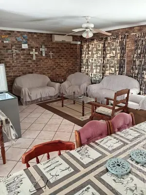 a living room with couches and tables in a room at IFAFA732 Akkommodasie in Leeupoort