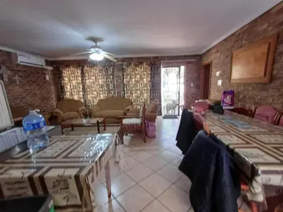 a living room with tables and chairs in a room at IFAFA732 Akkommodasie in Leeupoort