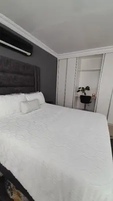a large white bed in a bedroom with a window at Palma Royal Ensuite in Pretoria