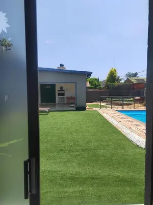 a view of a building with green grass at Palma Royal Ensuite in Pretoria