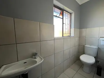 a bathroom with a toilet and a sink at 419 Guest House in Midrand