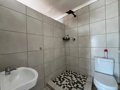 a bathroom with a sink and a toilet at 419 Guest House in Midrand