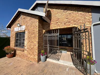 a brick building with a sign on it at 419 Guest House in Midrand