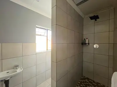 a bathroom with a shower and a sink at 419 Guest House in Midrand