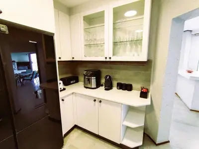 a kitchen with white cabinets and a coffee maker on a counter at Letamo View - 5 bedroom house in Hartbeespoort