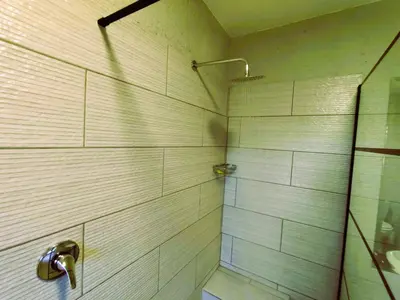a bathroom with a shower with a glass door at Letamo View - 5 bedroom house in Hartbeespoort