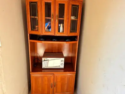 a wooden cabinet with a microwave on top of it at Dongodzi Lodge in Ha-Lambani