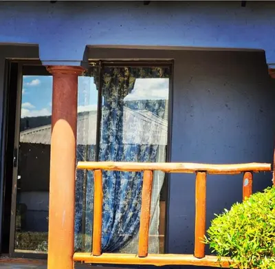 a window with a curtain on a porch at Dongodzi Lodge in Ha-Lambani