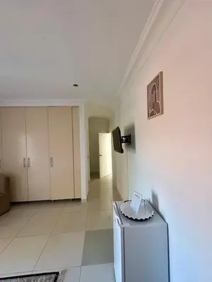 a living room with a refrigerator and a wall at The Homestead on Nutmeg in Pretoria