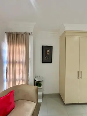 a living room with a couch and a window at The Homestead on Nutmeg in Pretoria