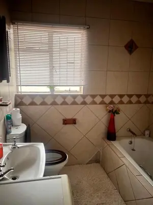 a bathroom with a sink and a toilet and a tub at 17 Byvanger Luxury Home Deluxe Queen Suite Room 2 in Centurion