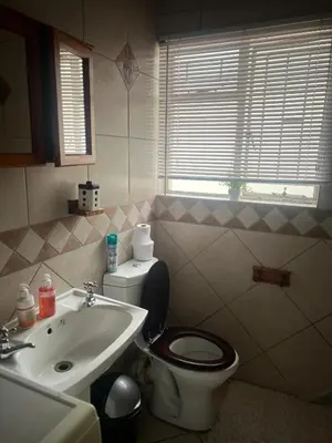 a bathroom with a toilet and a sink at 17 Byvanger Luxury Home Deluxe Queen Suite Room 2 in Centurion