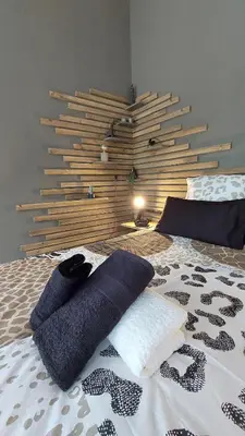a bedroom with a bed with two pillows on it at Bush Serenity Studio in Marloth Park