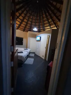a bedroom with a bed and a tv in a room at Afpak in Barberton