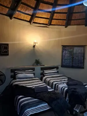 three beds lined up against a wall in a room at Afpak in Barberton