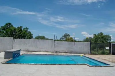a swimming pool in front of a fence at watershed Self catering in Phalaborwa