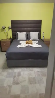 a dog laying on a blanket on a bed at watershed Self catering in Phalaborwa