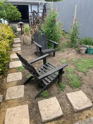 a wooden bench sitting in a garden with rocks at Seven in Secunda