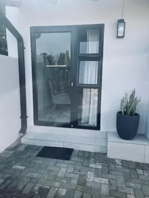 a front door of a house with a potted plant at Seven in Secunda