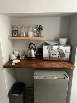 a shelf in a kitchen with a tea kettle on it at Seven in Secunda