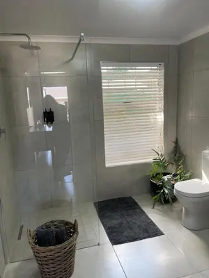 a bathroom with a shower and a toilet at Seven in Secunda