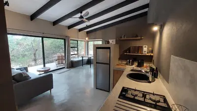 a kitchen with a stove and a counter top at Rock'N Round Marloth Lodge in Marloth Park