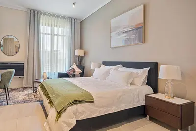 a bedroom with a large bed and a window at Menlyn Maine Luxury Studio King Bed Free parking 133 in Pretoria
