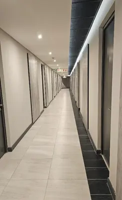 a hallway of an office building with a long corridor at Menlyn Maine Luxury Studio King Bed Free parking 133 in Pretoria