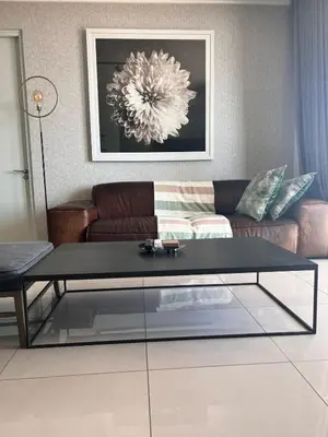 a living room with a couch and a coffee table at Kabazela at Ellipse in Midrand