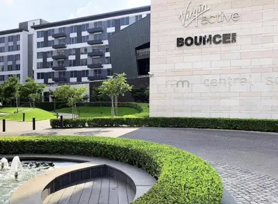 a building with a fountain in front of a building at Menlyn Maine Residence - Studio Apartment in Pretoria