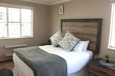 a bedroom with a large white bed with pillows at Hepzibah Manor in White River