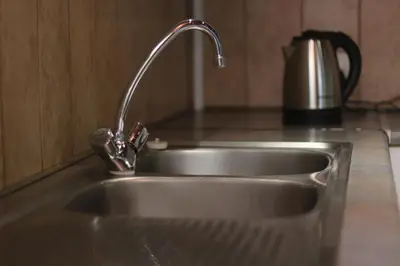 a kitchen sink with a faucet on a counter at Hepzibah Manor in White River