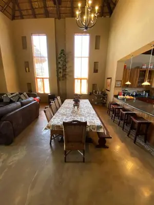 a large living room with a table and chairs at Zebula - African Dream A - Pax 8 in Warmbaths